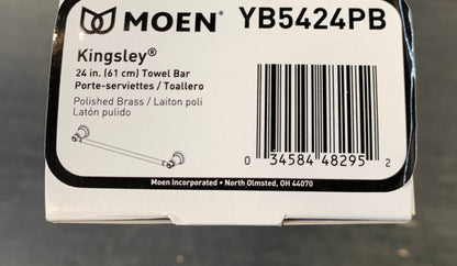 A white Moen YB5424PB product box for Kingsley Bells polished brass ladders, photographed on a gray floor.